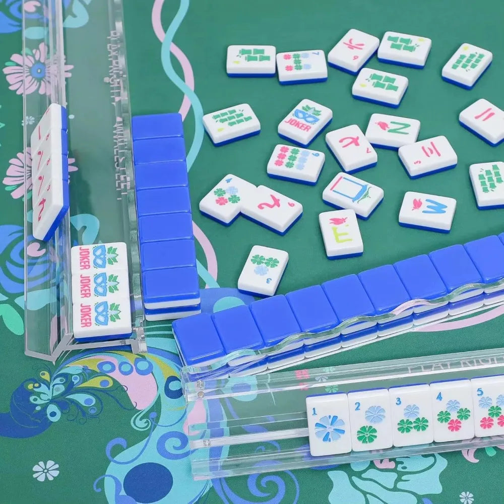 Clear acrylic mahjong racks holding tiles on a green mat